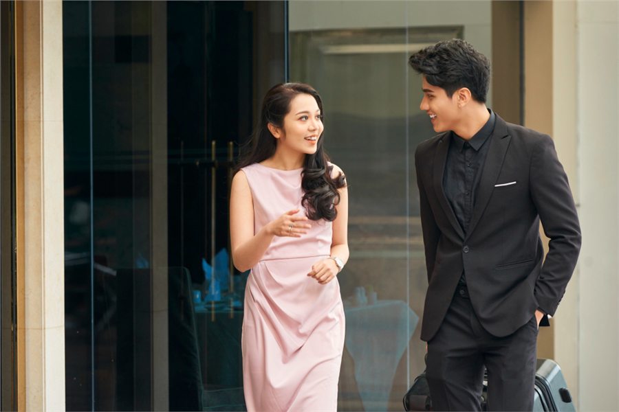 Stylish Malaysian couple walking together
